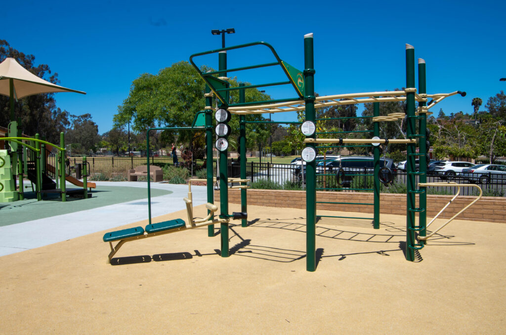 Outdoor fitness area with commercial exercise equipment at Jerabek Park in San Diego, California.