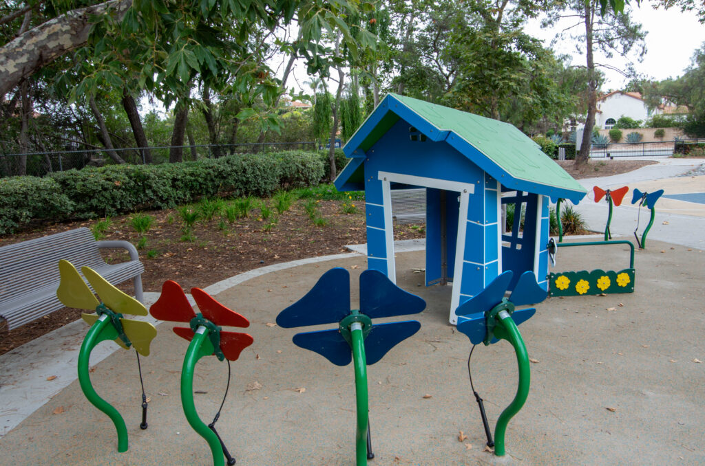 Sensory play area with colorful butterfly features and playhouse at Scott Valley Park in Encinitas.